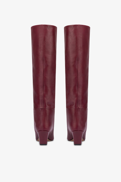 Knee-high, long pointed boot in supple rouge noir leather