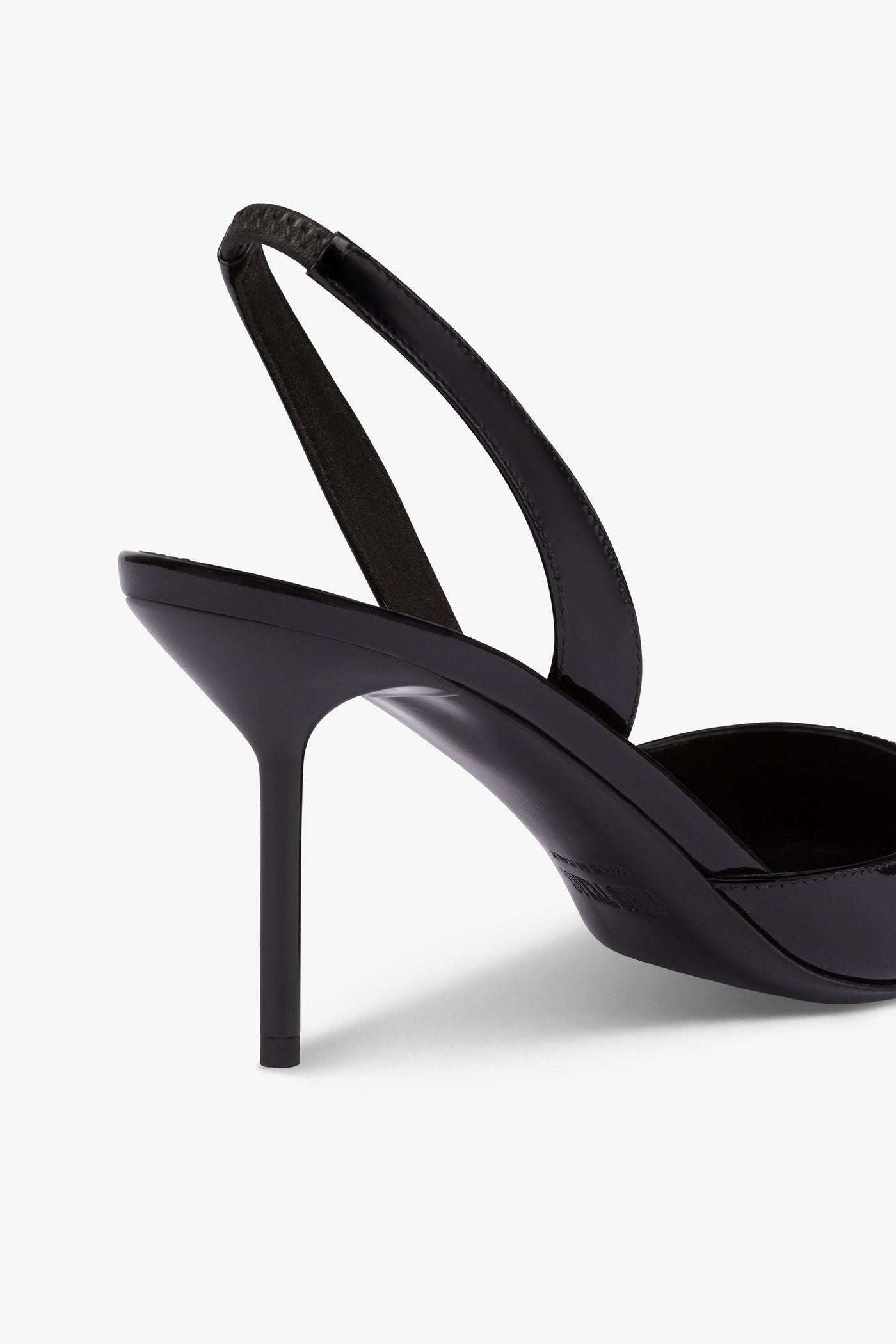 Long, pointed slingbacks in patent black leather