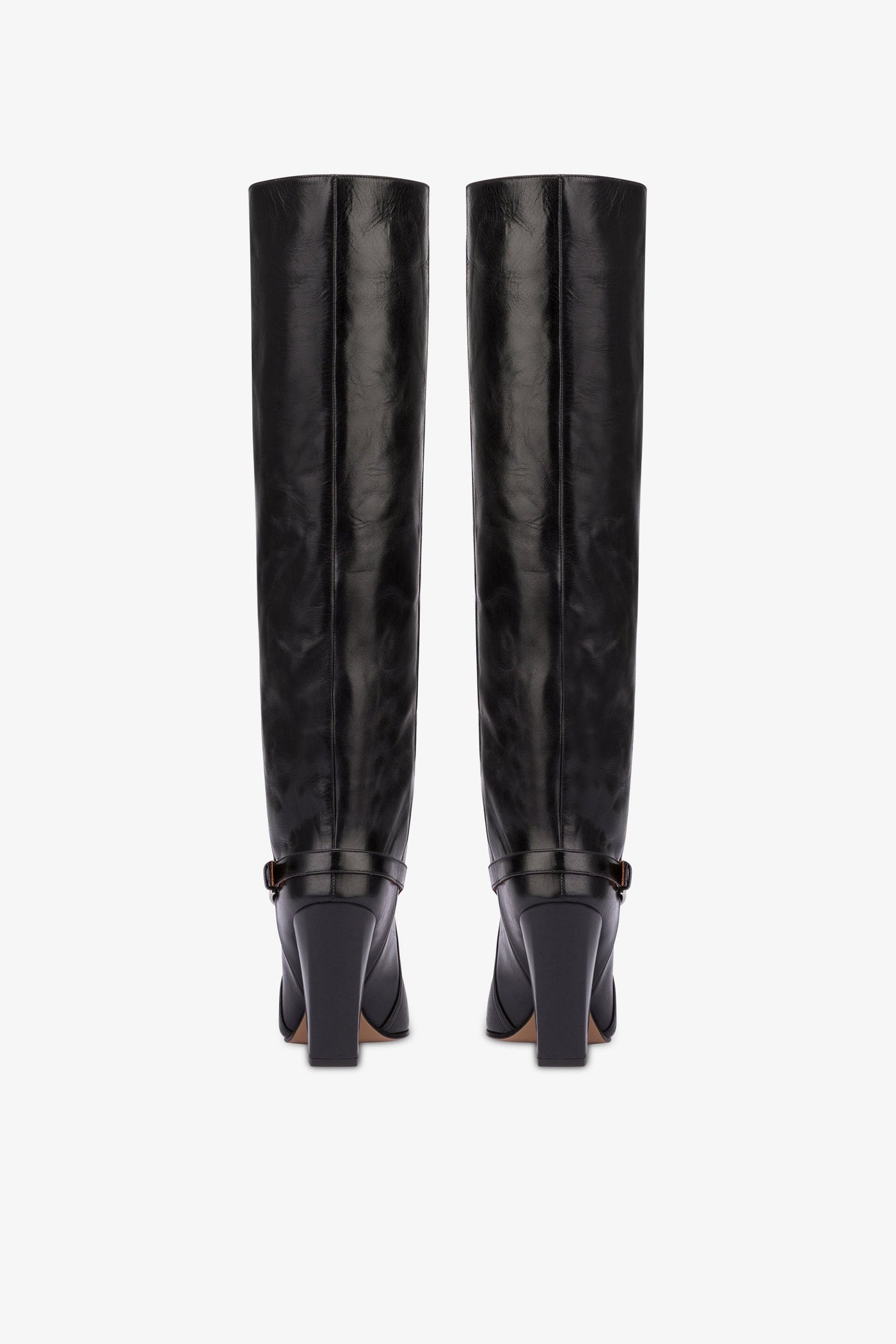 Tall, knee-high boots in shiny black vintage leather