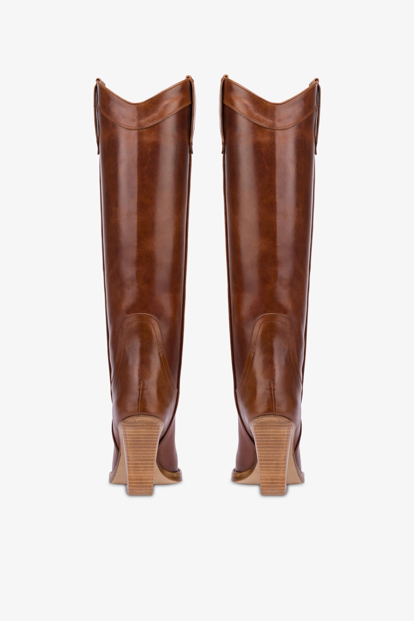 Pointed knee-high boots in shiny vintage leather