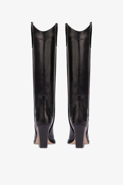 Pointed knee-high boots in black shiny vintage leather