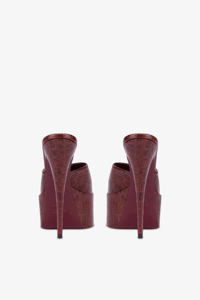 Almond-toe heeled mules in patent rouge noir leather